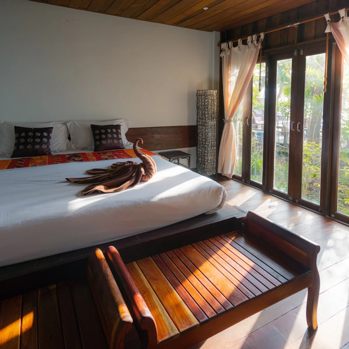Modern hotel bedroom interior with polished hardwood flooring
